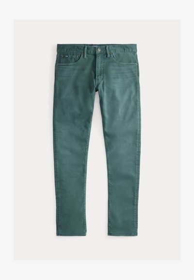 Zaļas kokvilnas džinsi ar šauru piegriezumu. Iespējas: divas priekšējās kabatas, rāvējslēdzēja aizdare un kontrastējoša šuvju krāsa. Gluda tekstūra, vienmērīga krāsa.