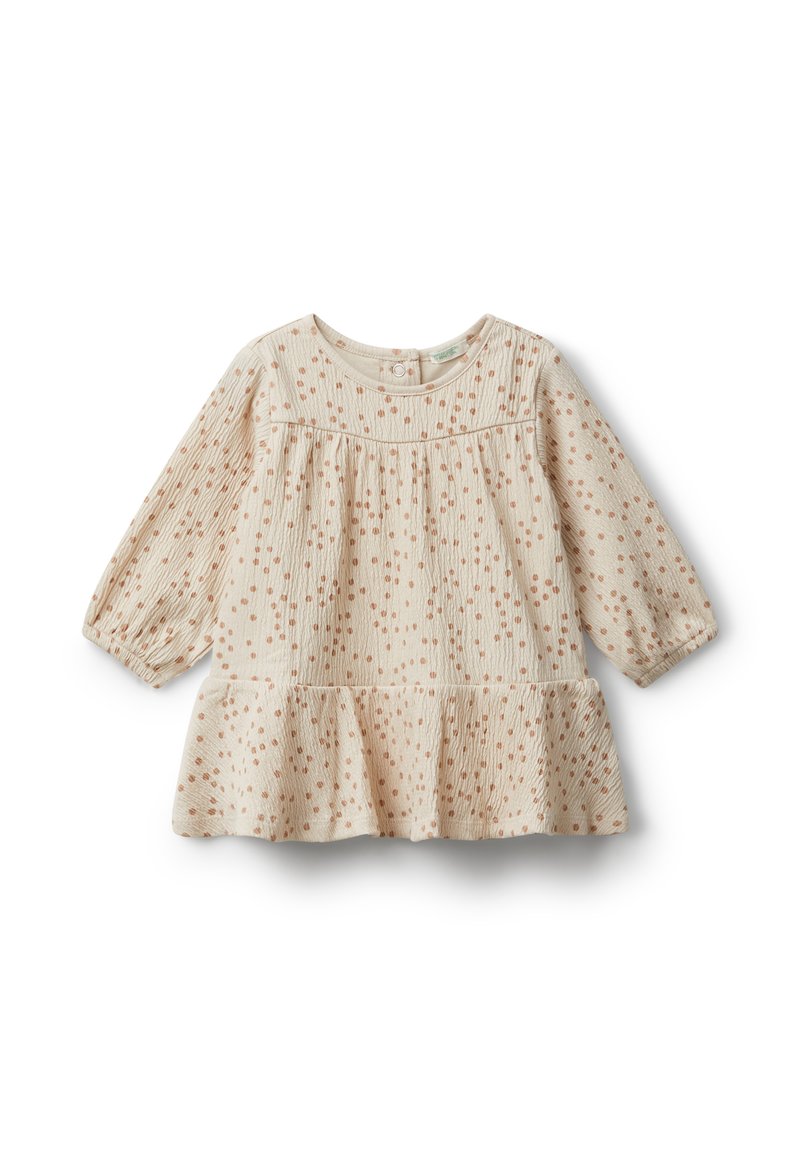 Svetle béžové šaty s texturovanou tkaninou, zdobené malými rezavými tečkami. Mají dlouhé rukávy a volánkový lem na spodní části.