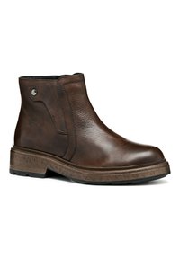 Botas de tobillo de cuero marrón con acabado texturizado, paneles laterales elásticos, puntera redonda y suela de goma robusta con ligera elevación.