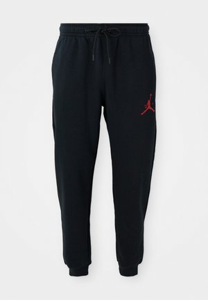 Black joggers with elastic waistband and drawstring, cuffed ankles, and small red Jumpman logo on the upper left thigh.