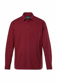 Maglietta a maniche lunghe color bordeaux con colletto e chiusura anteriore con bottoni. Presenta polsini con dettaglio a bottoni e una texture di materiale liscia.