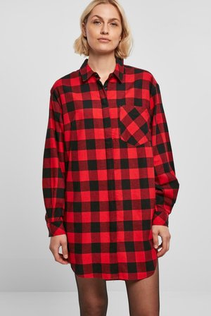 Chemise à carreaux rouge et noir, à manches longues, avec un design à boutons, poche poitrine, en matière coton, coupe décontractée, avec un ourlet légèrement arrondi.