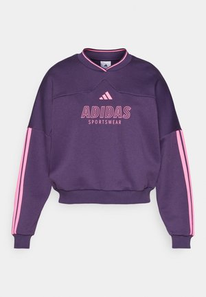 Purple cropped sweatshirt featuring pink stripes on sleeves, round neckline, and "ADIDAS SPORTSWEAR" printed across the front. Soft fabric.