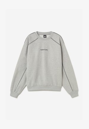 Helehall halli kaelusega dressipluus mustade nähtavate õmblustega ja "Kaotiko Society" tikitud tekstiga rinna keskel.