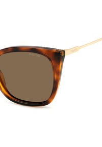 Occhiali da sole tartaruga con lenti marroni. Design oversized a occhio di gatto con braccio in metallo dorato. Sottile branding "Polaroid" sulla montatura.
