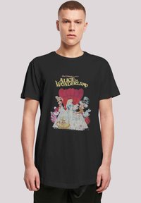 Black t-shirt featuring a vintage "Alice in Wonderland" graphic with colorful characters, highlighted by a distressed texture and bold lettering.