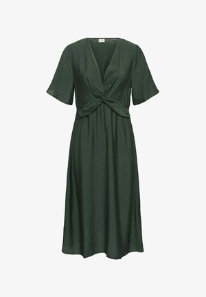 Roheline, põlvepikkune kleit kergest kangast; omab sügavat V-dekolteed, lühikesi kõikuvaid varrukaid ja sõlme detailiga vööd.