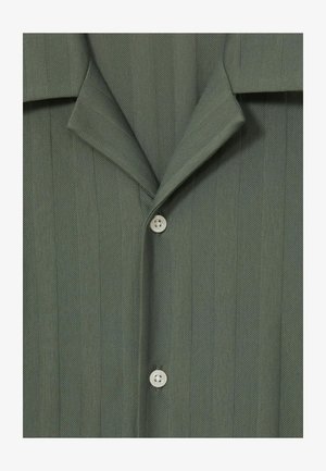 Green horizontal striped shirt with a soft texture, notched collar, and white buttons for closure. Close-up view highlighting fabric details.