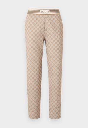 Pantalon ajusté beige avec un motif circulaire réparti sur toute la surface et une taille ornée de rayures horizontales avec le texte "JOOP!" au centre.