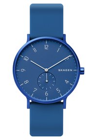Orologio blu con cinturino in silicone, caratterizzato da una cassa rotonda e un quadrante minimalista con indicatori delle ore, un piccolo sotto quadrante e lancette argentate.