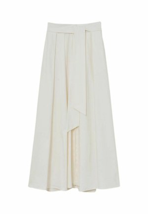 Kreemikas kõrge vöökohaga midi seelik, mis on ees volditud ja millel on lai sobivast materjalist vöö, mis ripub keskelt alla.