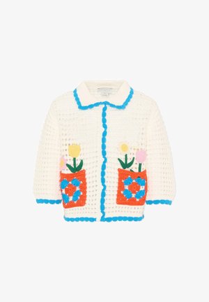Cardigan bianco all'uncinetto con bordo blu, due tasche anteriori arancioni con disegni floreali colorati che includono fiori gialli e rosa.