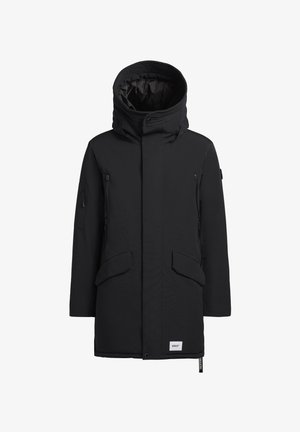 Melnā parka jaka ar kapuci, lielām priekšējām kabatām un ar rāvējslēdzēju aizveramām sānu kabatām. Izgatavota no gludas, ūdensizturīgas materiāla.