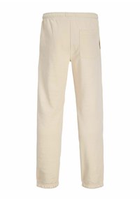 Beige katoenen sweatpants met een elastische tailleband, taps toelopende pijpen en een enkele achterzak. Gladde textuur met een eenvoudig ontwerp.