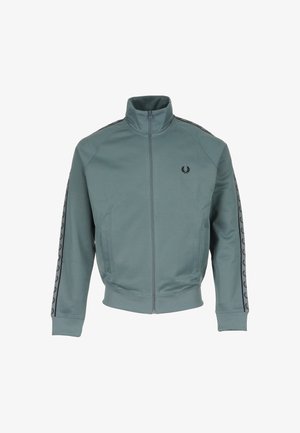 Veste de jogging zippée teal avec col montant, logo de laurier noir sur la poitrine et bandes noires avec logo le long des manches.
