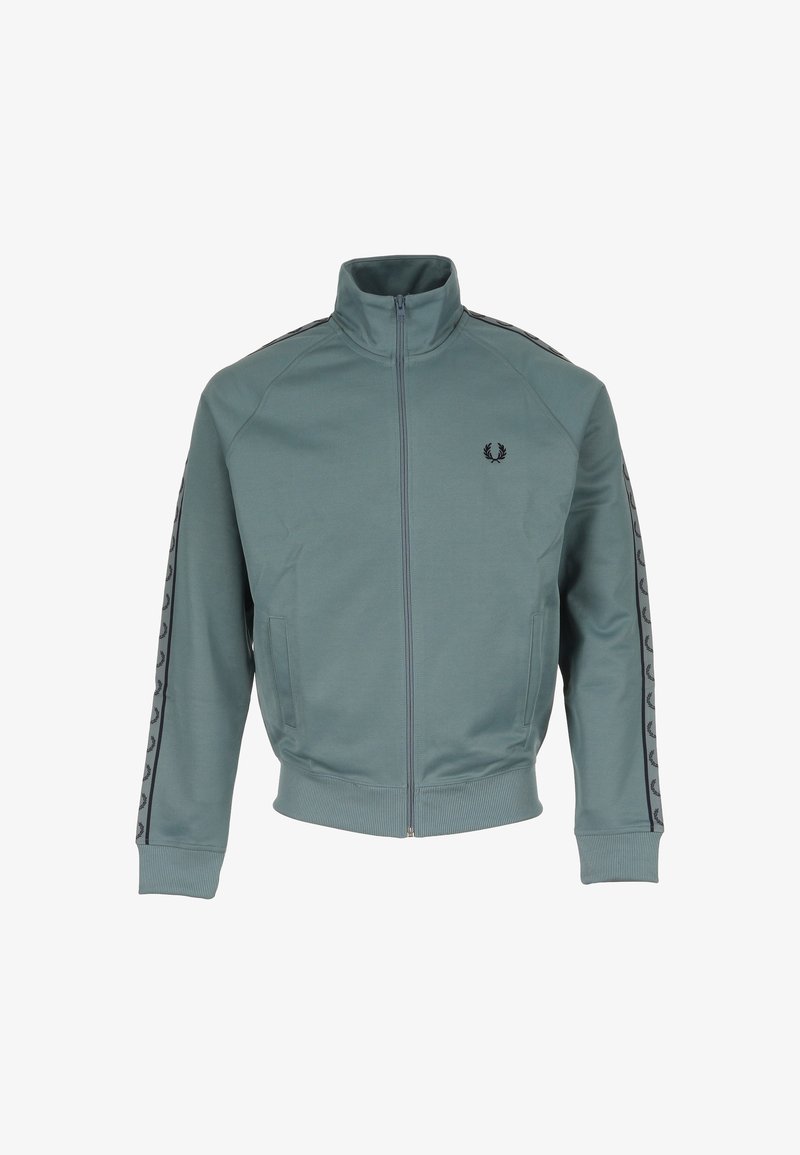 Veste de jogging zippée teal avec col montant, logo de laurier noir sur la poitrine et bandes noires avec logo le long des manches.