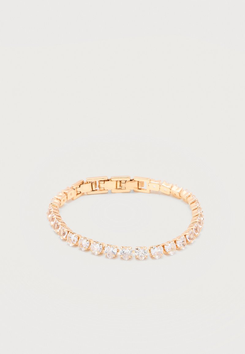 Χρυσό βραχιόλι με διαυγή στρογγυλά πολύτιμα πετράδια κομμένα σε στρογγυλό σχήμα τοποθετημένα σε συνεχή γραμμή, με κούμπωμα, σε λευκό φόντο.