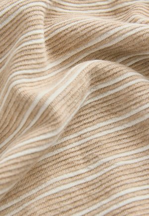 Textured fabric in beige with white stripes. Features a ribbed pattern, showing soft, flexible material that drapes naturally.