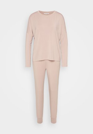 Top a maniche lunghe, dalla vestibilità comoda, e pantaloni affusolati in morbido tessuto rosa pallido. Miscela di cotone con texture liscia e polsini a costine sui pantaloni.