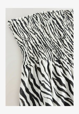 Potisk s pruhy zebry v černobílé barvě s nařasenou horní částí a strukturovaným efektem. Lehce splývavý materiál vhodný pro oděvy.