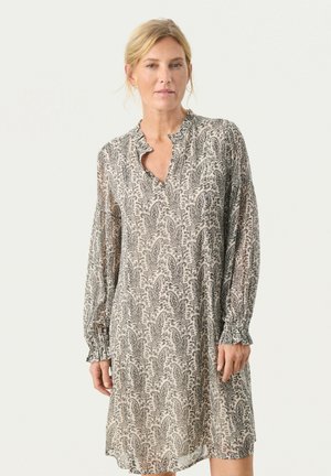 Langdurige jurk van lichtgewicht stof met een beige achtergrond en zwart bloemenpatroon, met een kraag halslijn en geplooide manchetten.
