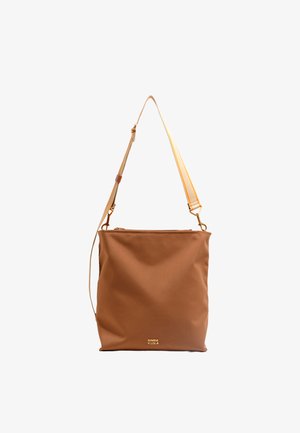 Ruda drobė tote krepšys su užtrauktuku, nuimamu reguliuojamu dirželiu ir auksiniu logotipu apačioje.