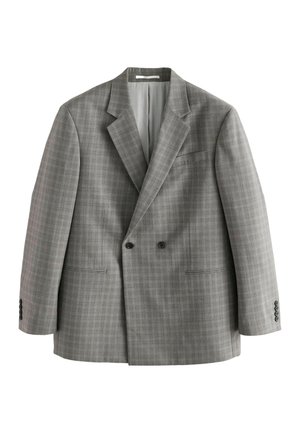 Hand adjusting the cuff of a gray plaid suit jacket with four black buttons.