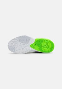 White sneaker sole with zigzag tread pattern. Accents in bright green with a logo detail. Smooth texture and rounded shape.