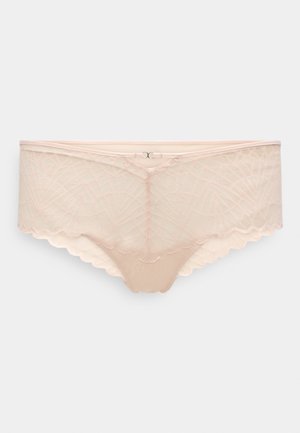 Nuda nėriniuotė apatinių drabužių su banguotais kraštais, puošta geometriniu raštu ir minkšta, permatoma tekstūra. Platus elastinis juosmuo.