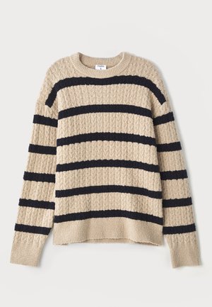 Beige knitted sweater with dark navy horizontal stripes, featuring a textured pattern and ribbed cuffs. Round neckline and relaxed fit.