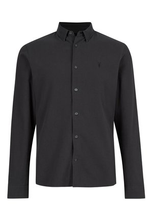 Camisa de manga larga negra de algodón. Cuenta con un cuello abotonado, una tapeta de botones en la parte delantera y un pequeño logo en el lado izquierdo del pecho.