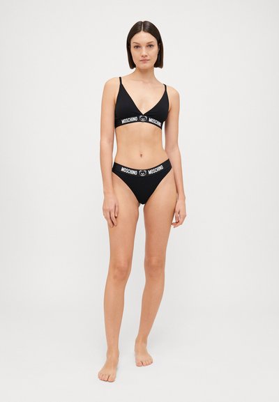 Black bikini set featuring a triangle bralette and low-rise bottoms, both with branded elastic bands. Smooth, stretchy fabric.