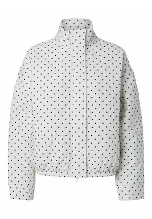 Veste matelassée blanche à pois noirs, col montant, ourlet élastique, manches longues, fermeture éclair et boutons-pression dissimulés à l'avant.
