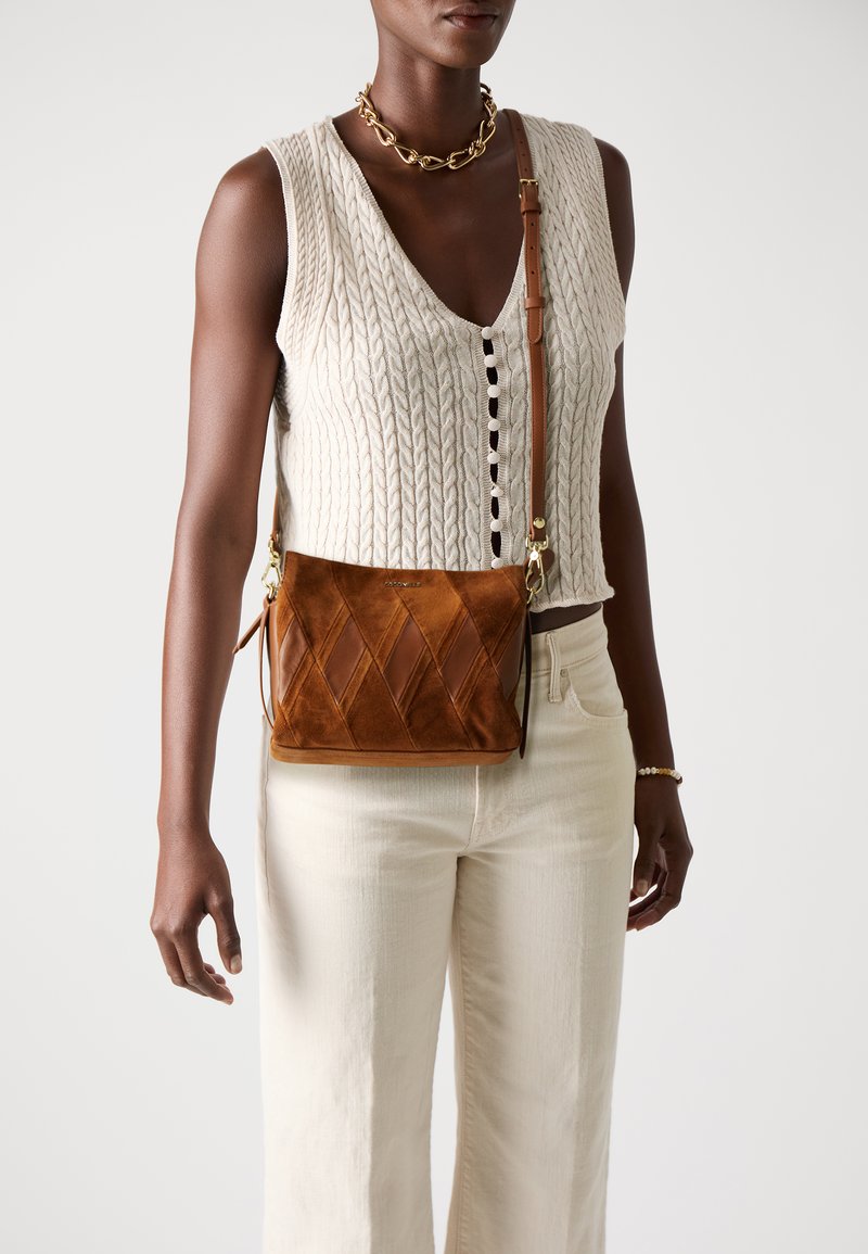 Brown suede crossbody bag with a quilted design, featuring a detachable strap and gold-tone hardware. Textured surface with solid accents.