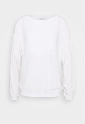 Biały top z długim rękawem, okrągłym dekoltem, elastycznym dołem i mankietami. Wykonany z miękkiego, lekkiego materiału o gładkiej strukturze.
