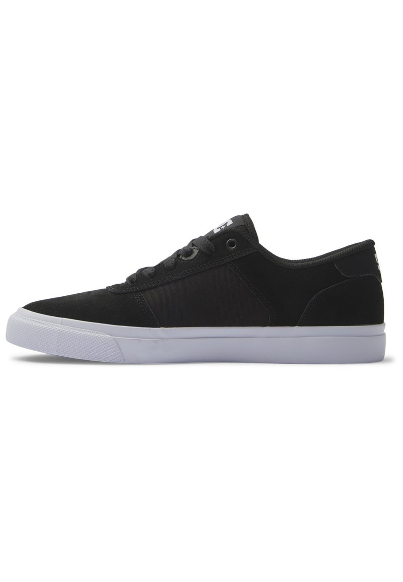 Black sneaker with a smooth suede and textile upper, white rubber sole, six eyelet lace-up design, and logo detail on the heel.