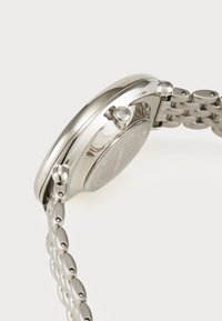 Stainless steel watch with a polished round case, mid-sized crown, and link bracelet featuring oval-shaped links. Smooth silver surface.