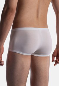 Men's white boxer briefs made of smooth cotton material with a snug fit, featuring a soft, elastic waistband and minimal stitching details.