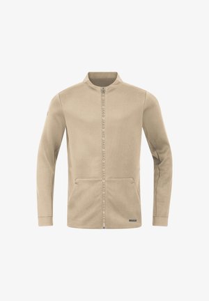 Beige Zip-Jacke mit hohem Kragen, ausgestattet mit zwei Fronttaschen und Branding entlang des Reißverschlusses. Weicher Stoff mit glatter Textur.