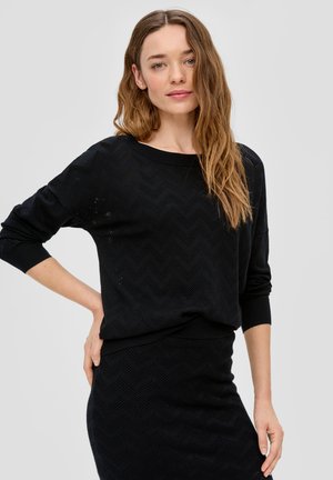Black knit sweater featuring a chevron pattern, round neckline, and three-quarter sleeves. The fabric has a textured, breathable design.