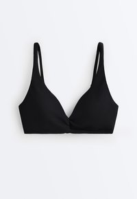 Soutien-gorge en tissu noir texturé avec fines bretelles réglables et détail torsadé à l'avant sur fond blanc.