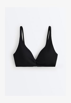 Zwarte textuurrijke stoffen bralette met dunne verstelbare schouderbandjes en een gedraaide voorkant, op een witte achtergrond.