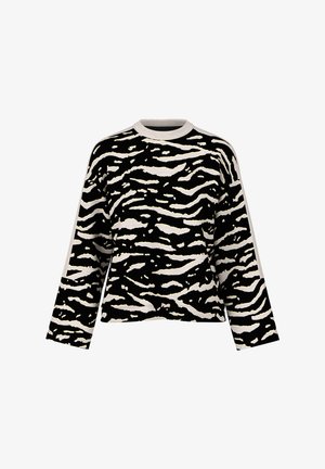 Black and cream zebra-striped sweater with long sleeves, crew neck, and a relaxed fit. Fabric texture appears soft and lightweight.