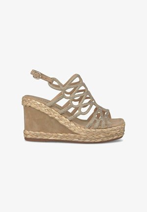 Beige wedge sandaal met een gevlochten jute zool, een bovenwerk met uitsparingen en decoratieve rhinestones op de bandjes. Gesp-sluiting voor een verstelbare pasvorm.