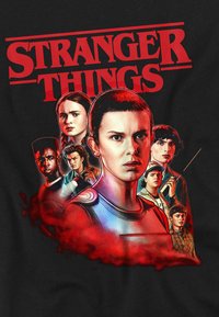 Maglietta Stranger Things Hawkins Heroes Group 1987 – Nero, Taglia 9-11, Cotone Pre-ritirato, Stampa Ufficiale, Per Bambini
