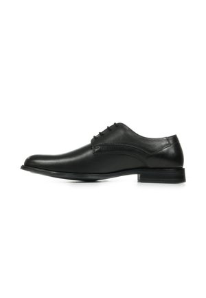 Chaussure habillée en cuir noir avec un bout arrondi, texture lisse, cinq œillets pour les lacets et un petit talon empilé.
