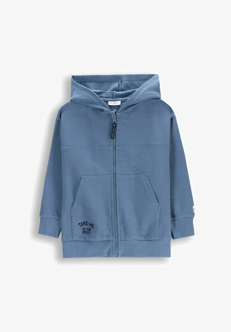 Niebieska bluza z zamkiem błyskawicznym, wykonana z teksturowanej tkaniny, z dwiema przednimi kieszeniami i nadrukowanym hasłem "ZABIERZ MNIE NA PLAŻĘ" w pobliżu kieszeni.