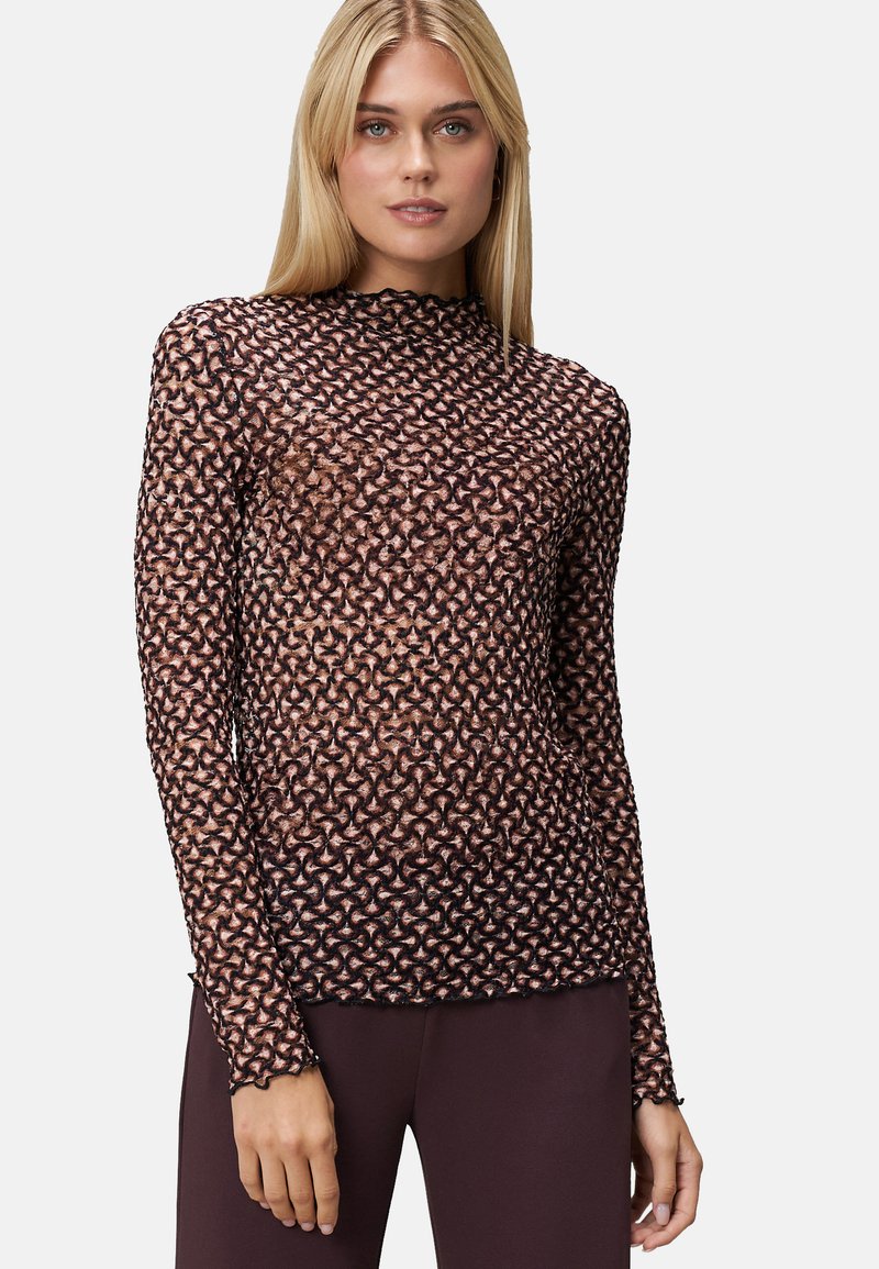 Pull à manches longues en tissu transparent à motif floral, avec un col haut, dans des teintes noir et or rose, et un design près du corps.
