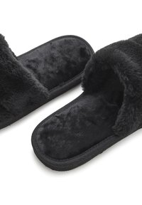 Black slippers with a soft faux fur lining and textured outer material. Open-toe design with a flat sole and stitched edges.