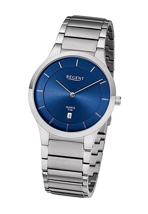 Montre en acier inoxydable argenté avec un cadran bleu rond, des marqueurs horaires argentés et un affichage de la date à 6 heures. Mouvements à quartz.